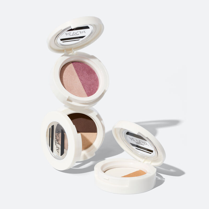 Open special-edition Mary Kay Eye Shadow Duo in Rosy Plum stacked on Choco Espresso compact with Gold Star compact to the right on white background