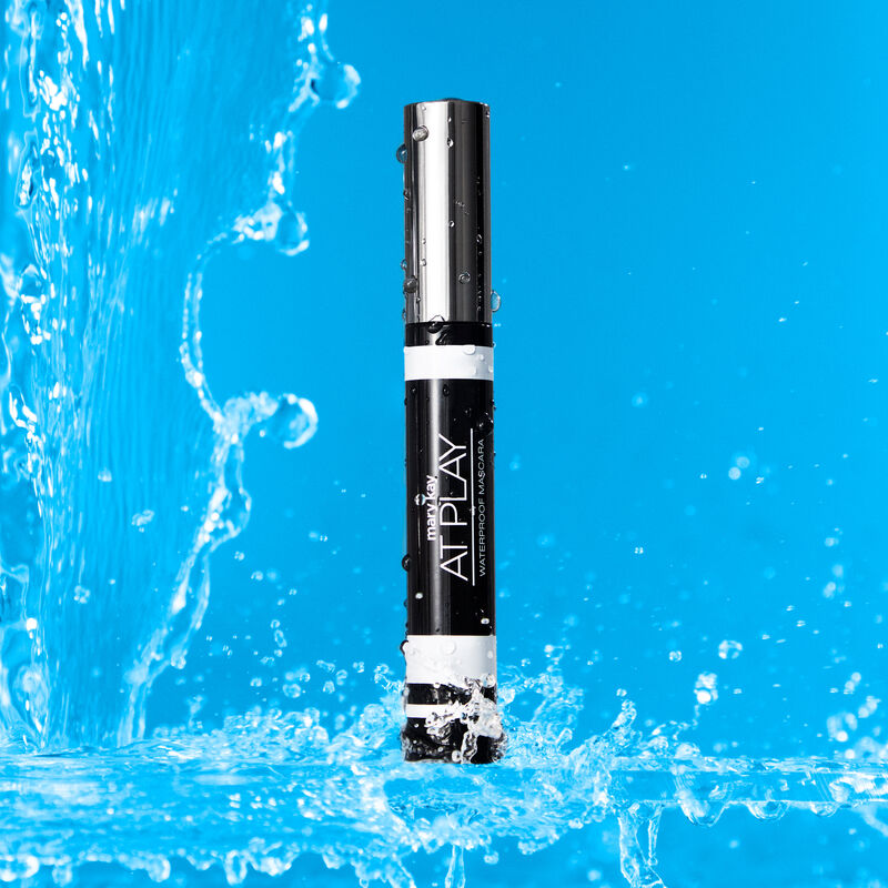 Closed tube of Mary Kay At Play Waterproof Mascara surrounded by splashing water