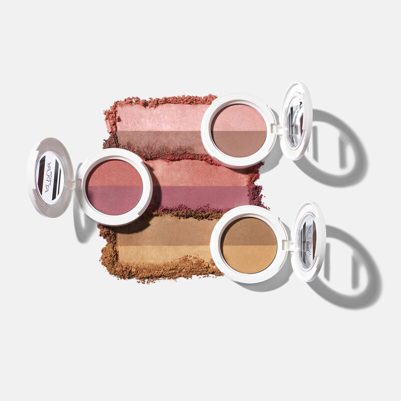 Open compacts of Mary Kay At Play Blush Duos and Mary Kay At Play Bronzer Duo with product rubs