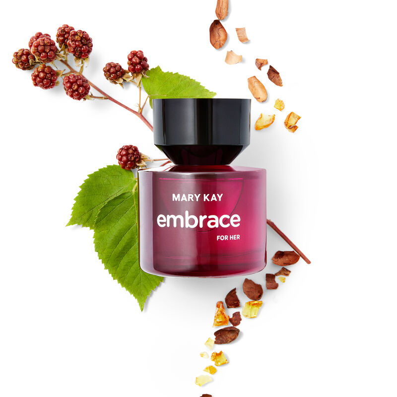 Ingredients that comprise the fragrance notes of Mary Kay Embrace for Her Eau de Toilette in their natural state styled around the fragrance bottle