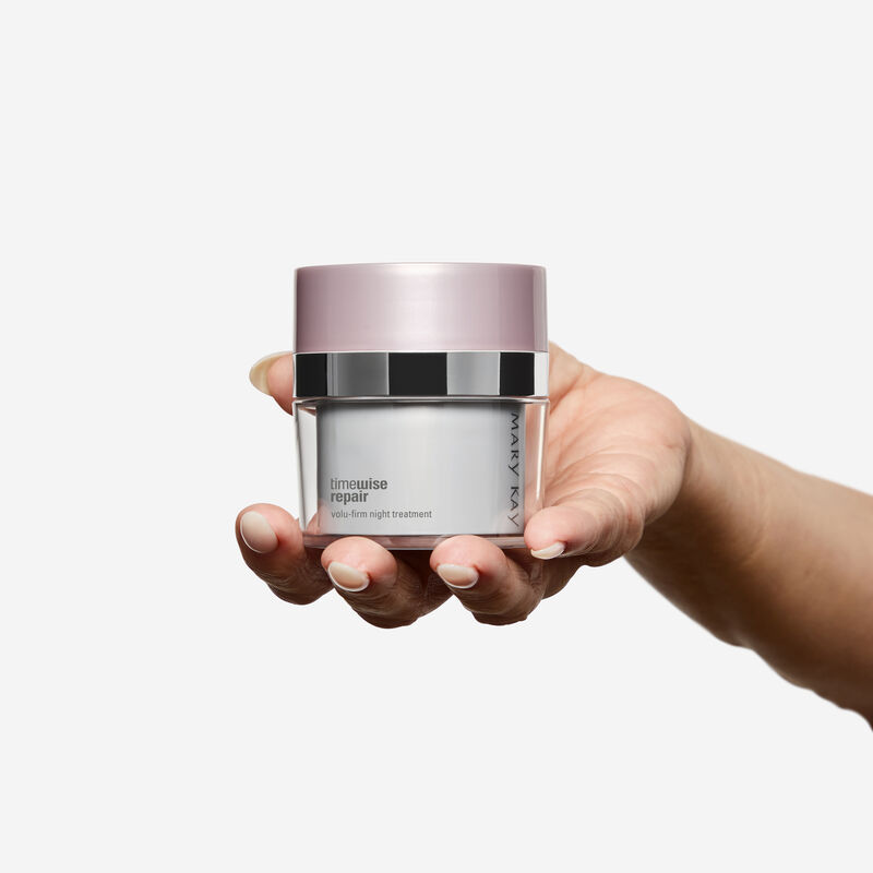 Hand holding Night Treatment jar