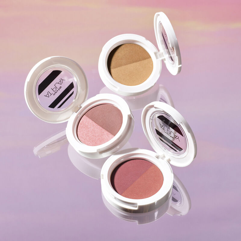 Open compacts of Mary Kay At Play Blush Duos and Mary Kay At Play Bronzer Duo against sunset-hued background