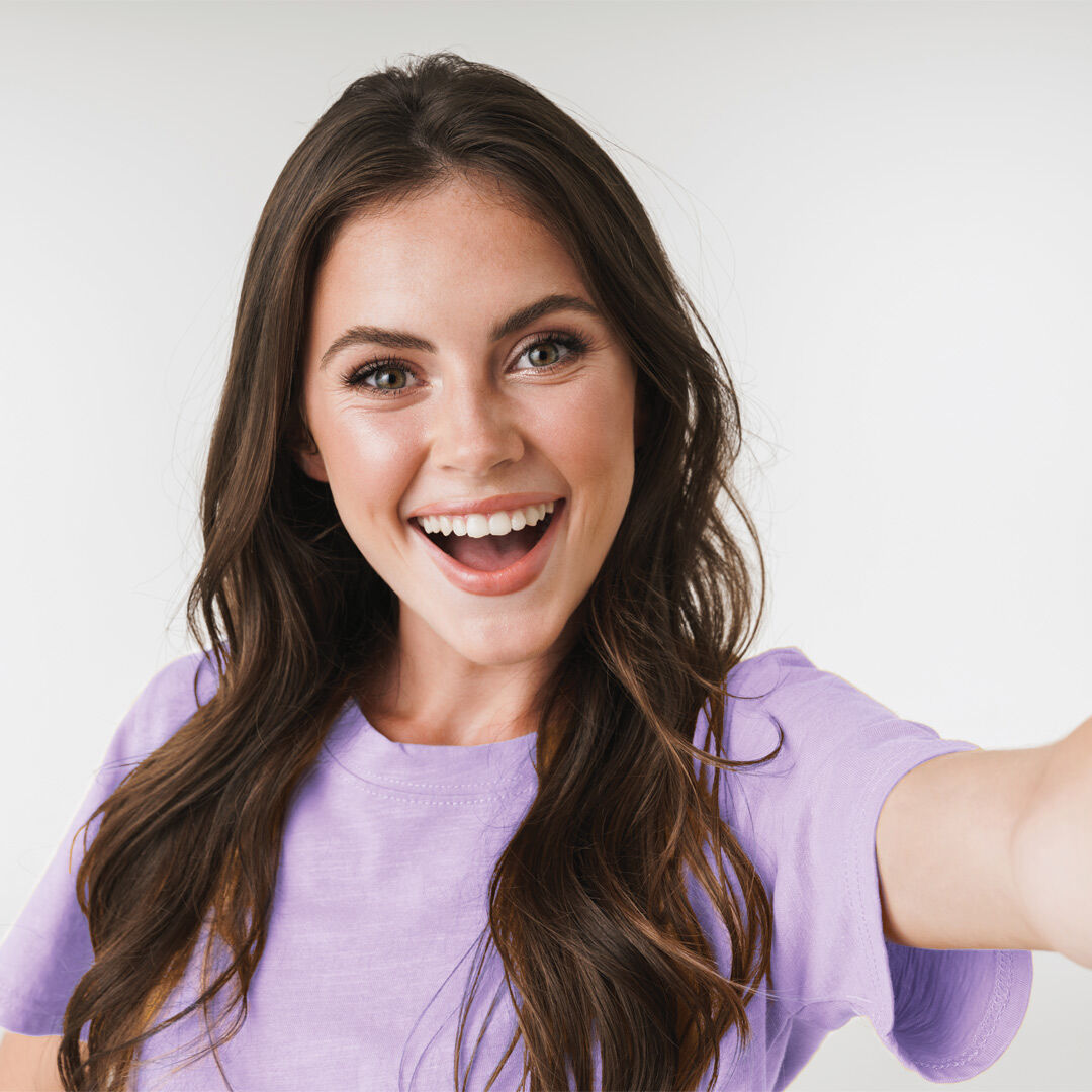 Woman smiling taking a selfie into the camera
